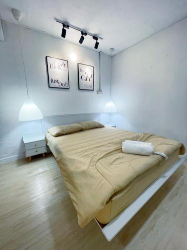 a large bed in a white room with two lamps at Kota Bharu RS Desa Roomstay in Kampong Haji Musa