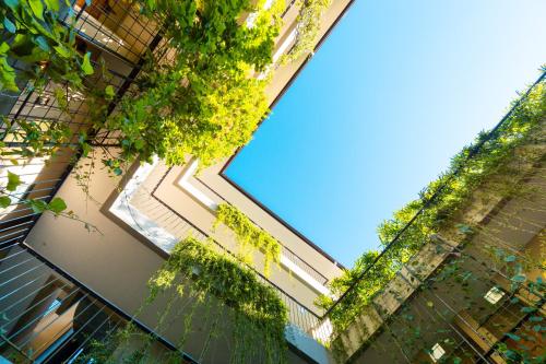 a large window in a building with plants at Tanaga CoLiving in Seminyak