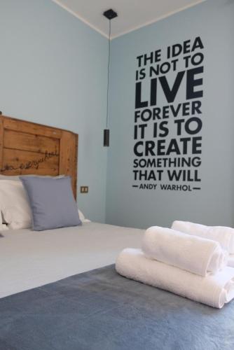 a bedroom with a bed with a poster on the wall at ADRIA ART APARTMENTS 1 in Adria