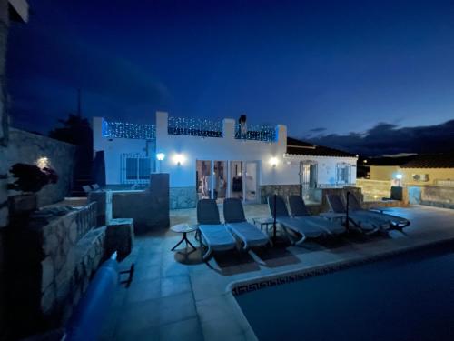 a villa with a swimming pool at night at Casa Olivia villa in Arboleas