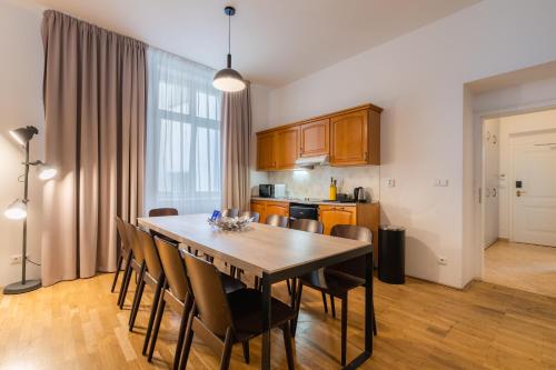 a kitchen with a dining room table and chairs at EA ApartHotel Melantrich in Prague