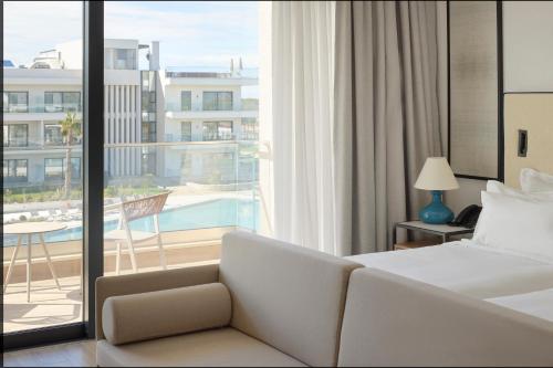 a hotel room with a bed and a balcony at Meliá Durrës Albania in Durrës