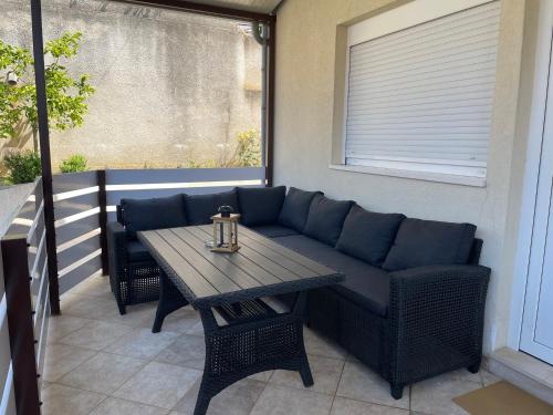 a patio with a couch and a table on a balcony at Apartments Molo Mare in Hvar