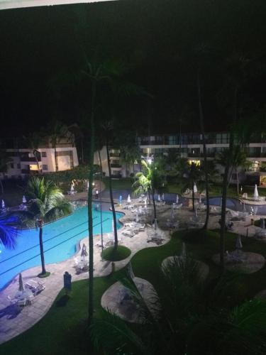 a view of a swimming pool at night at Estúdio Marulhos, varanda com vista de mar e parque aquático, à beira-mar de Muro Alto, wi-fi, restaurante, estacionamento e a 10' de Porto de Galinhas in Porto De Galinhas