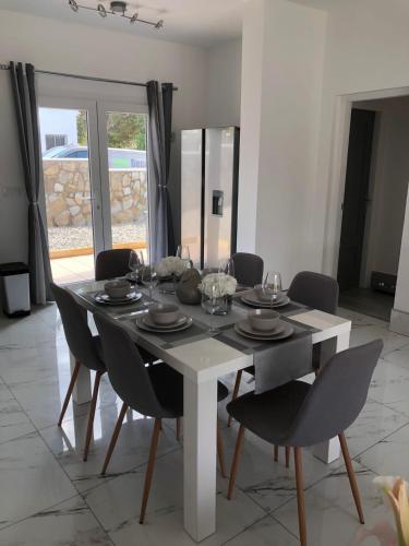 a dining room with a white table and chairs at Casa Olivia villa in Arboleas
