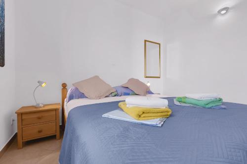 A bed or beds in a room at Apartments Lucija