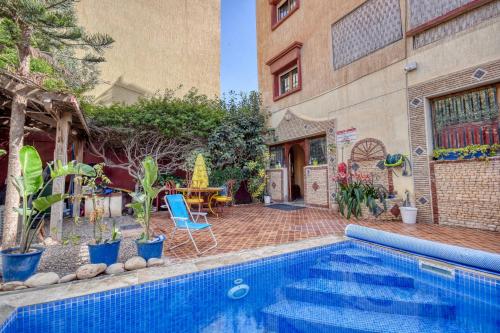a swimming pool in front of a building at Villa Eden - Piscine - 8PX in Tamraght Ouzdar