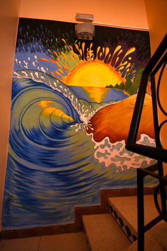 a painting of a wave on a wall at Villa Eden - Piscine - 8PX in Tamraght Ouzdar