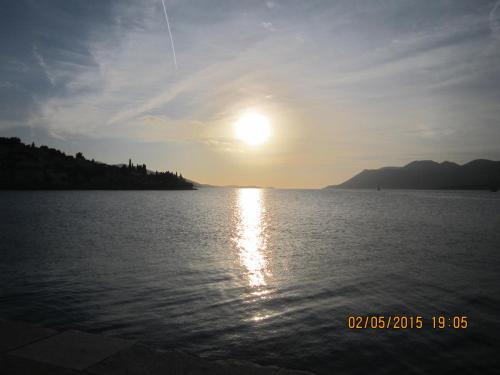 a sun setting over a large body of water at Guesthouse Korkyra Sun in Korčula