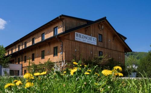 a barn with a sign on the side of it at Aktivhotel Wildschütz in Gmunden
