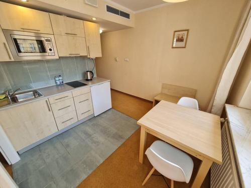 a small kitchen with a table and a counter top at 10Q - Z6 Apartment 205 in Warsaw