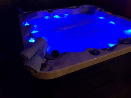 a hot tub with blue lights in a dark room at Mediterranean ocean view 4star appartment in Villa in Rijeka
