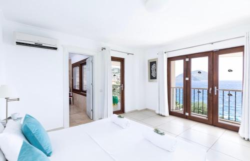 a bedroom with a bed and a view of the ocean at The Korsan Kuzey in Kas