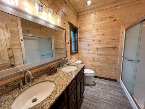 a wooden bathroom with two sinks and a toilet at * * 4 Master Bedrooms, Views, Theater, Arcade, EVC in Gatlinburg