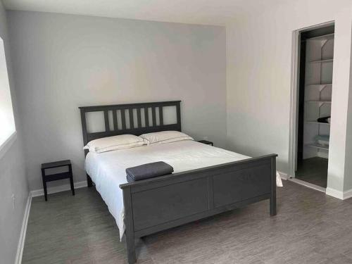 a bedroom with a large bed with white sheets at Sweet Home - 20 minutes to NYC in Jersey City