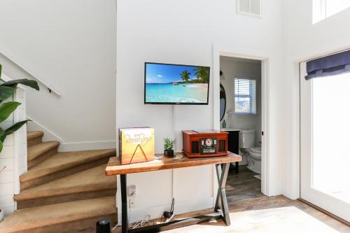 a living room with a table and a tv on the wall at Eagle's Rest by Pristine Properties Vacation Rentals in Indian Pass