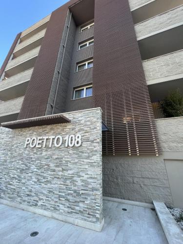 a sign in front of a building at Helios Guest House in Cagliari