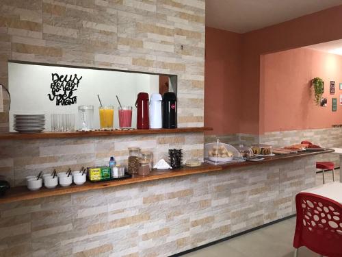 a restaurant with a counter with drinks on it at Pousada Maria do Ceú in Guaramiranga