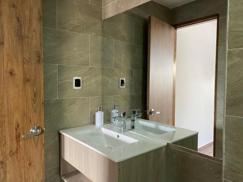 a bathroom with a sink and a mirror at Hotel Gran Plaza San Agustin in San Agustín