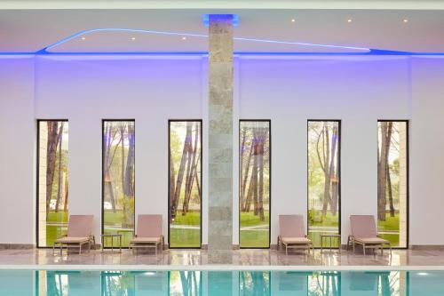 a lobby with chairs and a glass floor at Meliá Durrës Albania in Durrës