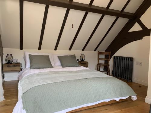 a bedroom with a large bed in a attic at St Milburga Chapel 