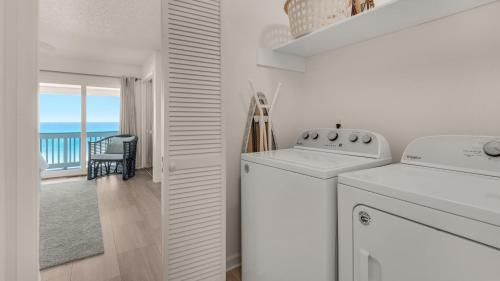 a white laundry room with a washer and dryer at Blue Nine 3 in Panama City Beach