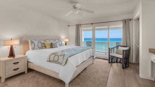 a bedroom with a bed and a view of the ocean at Blue Nine 3 in Panama City Beach