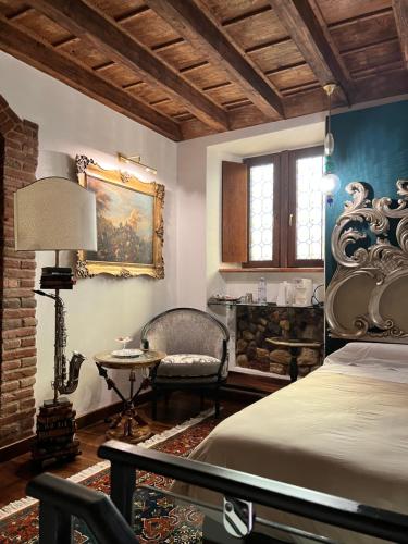 a bedroom with a bed and a table and a chair at Marcello Sleep&Spa in Verona