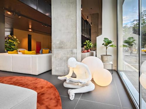 a living room with a white statue sitting on the floor at Occidental Diagonal 414 in Barcelona
