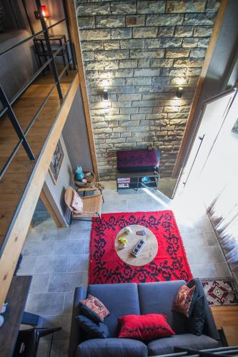 a living room with a couch and a stone wall at Acorn's Houses, Gray and Green Acorn in Kalloní