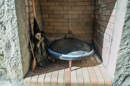 a dog sitting in a bath in a brick wall at Acorn's Houses, Gray and Green Acorn in Kalloní