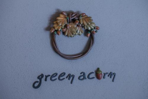 a picture of a green acorn on a white background at Acorn's Houses, Gray and Green Acorn in Kalloní
