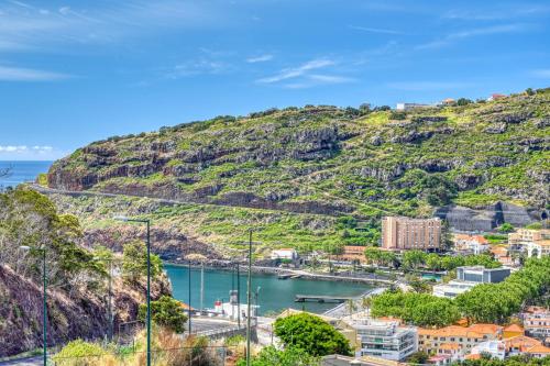 a view of a town on a hill at Baia Machico, a Home in Madeira in Machico
