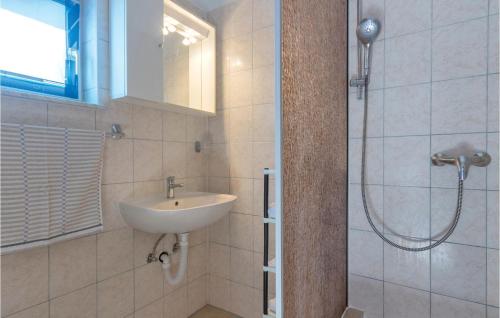 a bathroom with a sink and a shower at 2 Bedroom Gorgeous Apartment In Peroj in Peroj