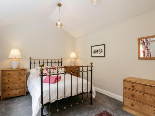 a bedroom with a bed and two night stands at The Cow Shed in Stroud