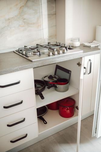 a kitchen with a stove and some pots and pans at Adrian Home Delice in Ploieşti