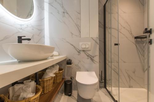 a bathroom with a sink and a toilet and a shower at Lux Ella Apartment in Makarska