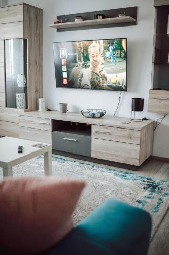 a living room with a flat screen tv on a wall at Adrian Home Delice in Ploieşti
