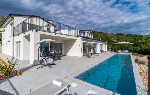 a villa with a swimming pool and a house at Villa Green Wave in Kostrena