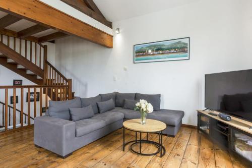 a living room with a couch and a table at Duplex Luzien - Welkeys in Saint-Jean-de-Luz