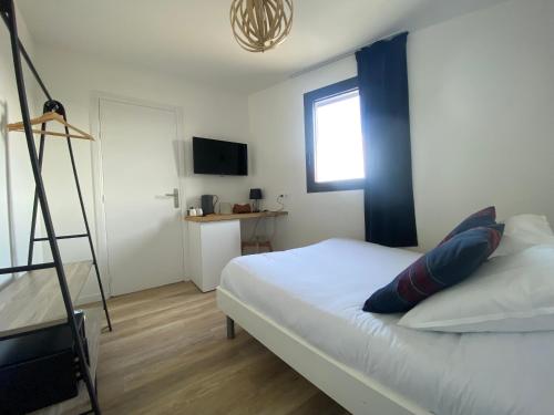 a bedroom with a bed with a ladder and a window at LA TOUR AUX CRABES près de la plage in Dieppe
