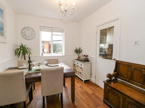 a dining room with a table and a piano at 2 Hartburn Road in North Shields