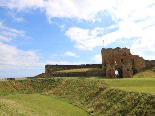 a castle on top of a hill with a green yard at 2 Hartburn Road in North Shields