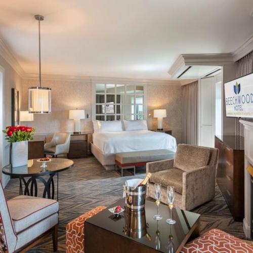 a hotel room with a bed and a living room at Beechwood Hotel in Worcester