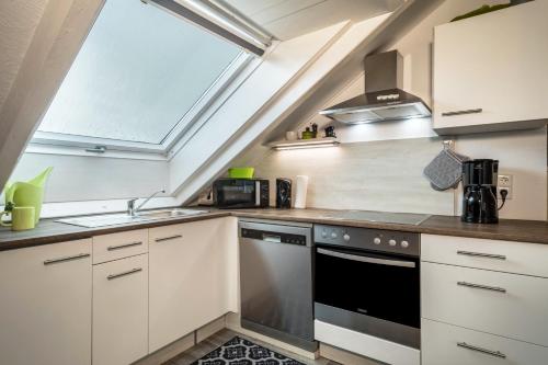 a kitchen with a sink and a stove at Straub in Meckenbeuren