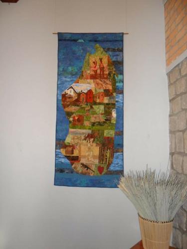 a painting hanging on a wall next to a vase at Hotel Ambalakely in Ambalakely