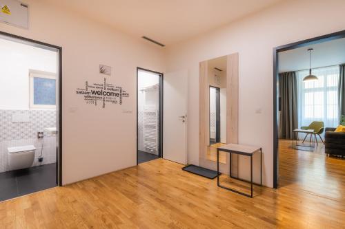 a room with a bathroom with a toilet and a table at EA ApartHotel Melantrich in Prague