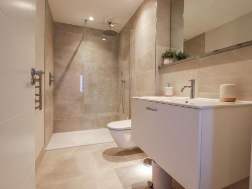 a bathroom with a sink and a toilet and a shower at 7 Longshore in Newquay