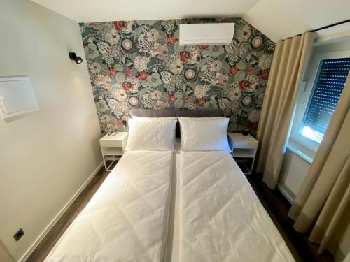 a bed with two pillows in a room at Boutique hotel ZBILJE in Zbilje