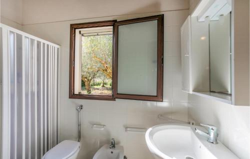 a bathroom with a sink and a toilet and a window at Gorgeous Home In Comiso With Wifi in Comiso